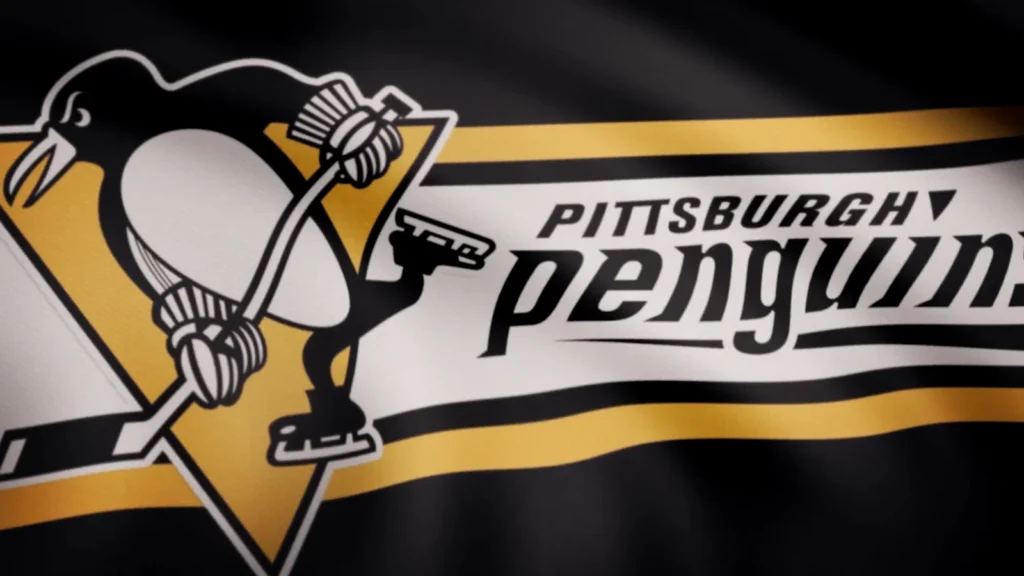 Closeup of waving flag with Pittsburgh Penguins NHL hockey team logo.