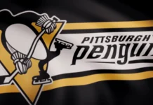 Closeup of waving flag with Pittsburgh Penguins NHL hockey team logo