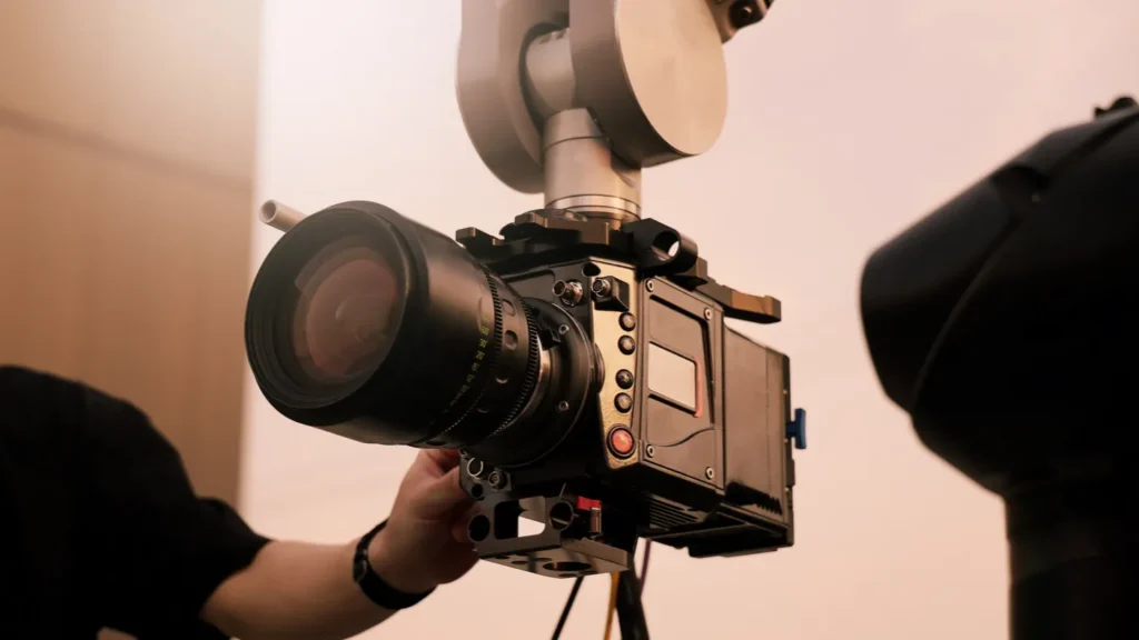 Video or film production with high tech robotic arm equipped with a professional cinema camera Operated by a cinematographer Advanced motion control system enables precise camera movements filming