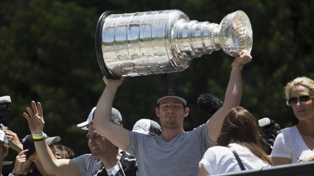 Goalie Jonathan Quick holding the Stanley Cup.