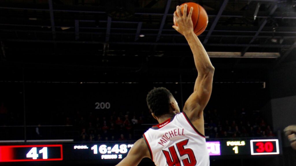 Donovan Mitchell making a dunk during a basketball match.