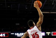 Mitchell leads Cavs past Pacers with 38-point performance Donovan Mitchell making a dunk during a basketball match.