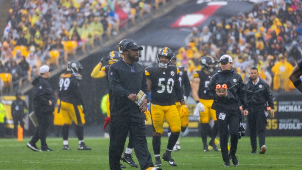 Mike Tomlin, head coach of Pittsburgh Steelers on the field with players.