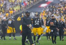 Mike Tomlin, head coach of Pittsburgh Steelers on the field with players