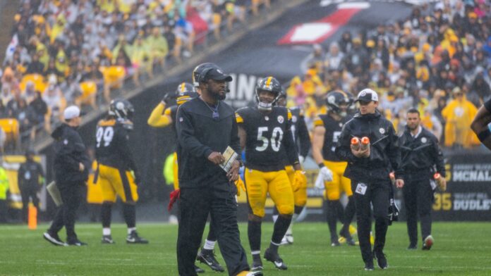 Shutterstock_mike tomlin (coach), pittsburgh steelers_ 2383235937 Mike Tomlin, head coach of Pittsburgh Steelers on the field with players
