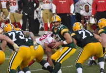 Green Bay Packers quarterback Aaron Rodgers looking to pass the ball during a football game.