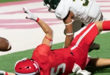 Alt: Football players making catches and running during a competitive game
