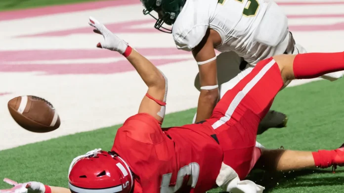 Alt: Football players making catches and running during a competitive game