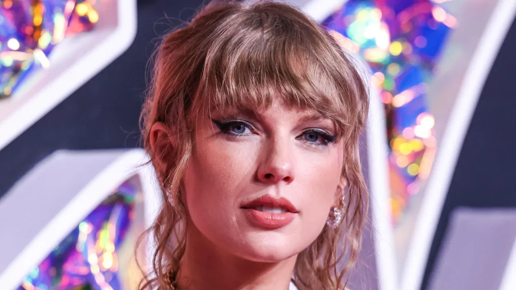 Taylor Swift looking into the camera at an event.