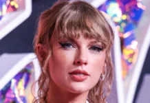 Taylor Swift visits Travis Kelce during NYC shoot for Tommy Hilfiger campaign Taylor Swift looking into the camera at an event.