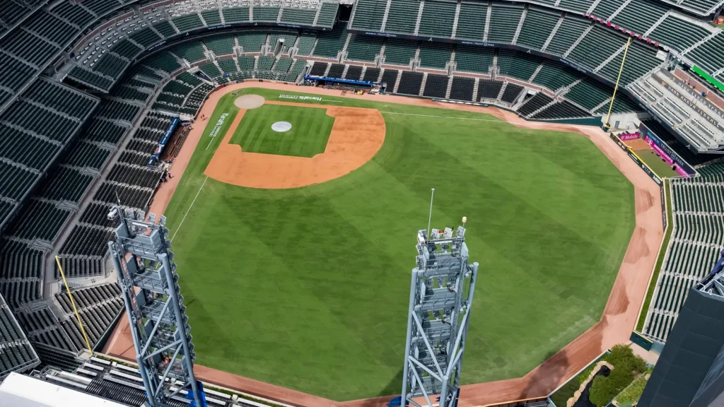 An aerial view of Truist Park showcases a modern baseball stadium nestled in the suburban landscape of Cobb County Surrounded by The Battery Atlanta green spaces and highways the park blends seamlessly into the bustling Cumberland community with