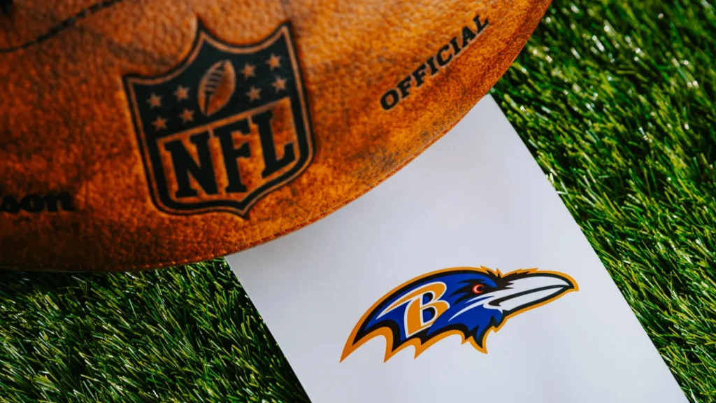 BALTIMORE USA FEBRUARY 10 2025 Baltimore Ravens NFL team Logo and American football ball on Green Grass