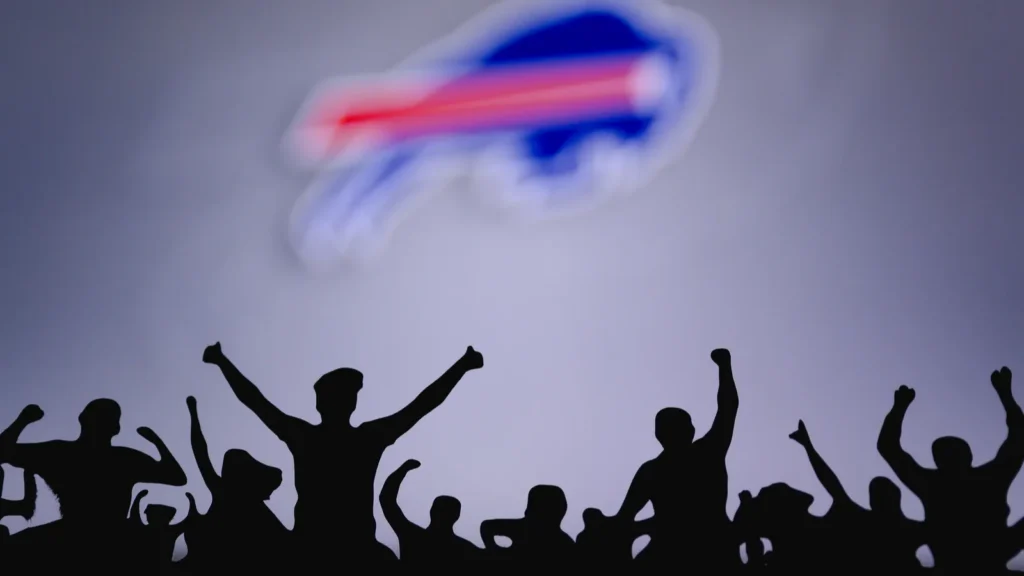 Buffalo Bills Fans support professional team of American National Foorball League Silhouette of supporters in foreground Logo on the big screen