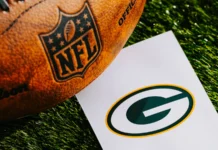 Bears-Packers game gets a major Week 5 schedule change Green Bay Packers NFL team Logo and American football ball on green grass
