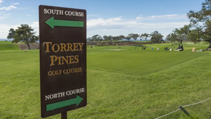 Torrey Pines Golf Course directional signpost with green fairway in background.