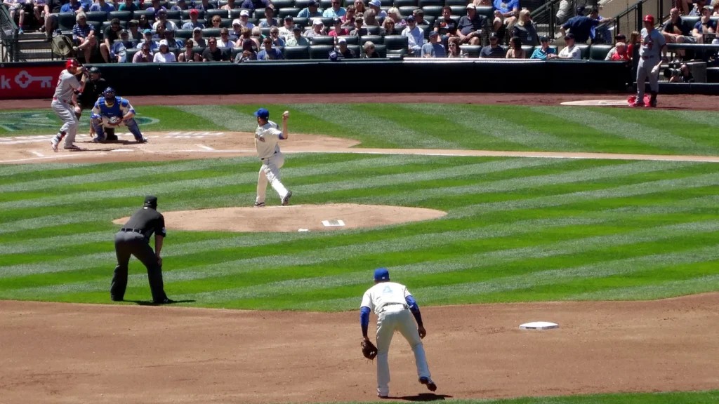 Mariners Pitcher steps forward to throw pitch to Cardinals batte