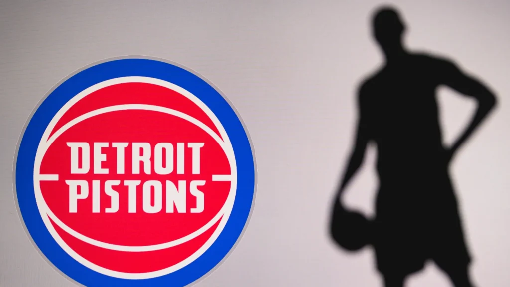 NEW YORK USA JUN 18 2020 Detroit Pistons logo of professional basketball club in american league Silhouette of basket player in foreground Sport concept photo edit space