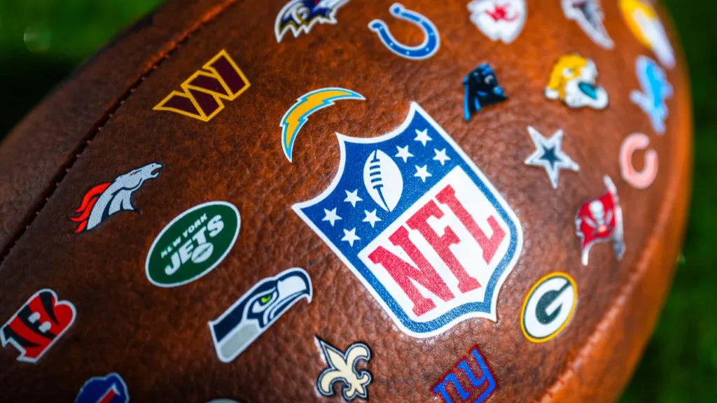 NFL All-Team Logo Football featuring the official National Football League shield logo surrounded by the throwback or current logos of all 32 NFL franchises.