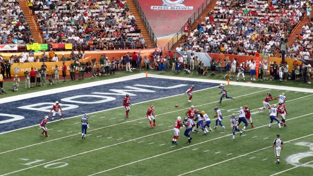 NFC Quarterback Drew Brees throws ball towards end zone with oth