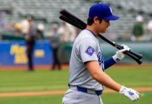 Los Angeles Dodgers designated hitter Shohei Ohtani walks on the field.