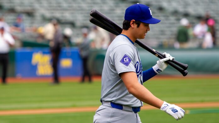 Los Angeles Dodgers designated hitter Shohei Ohtani walks on the field.