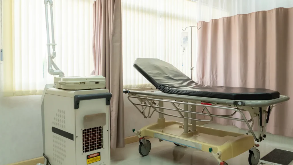 recovery room equipped with comfortable modern medical sickbed for patient