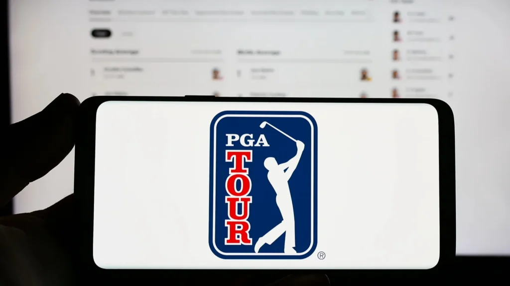 Stuttgart Germany  07172023 Person holding smartphone with logo of US golf organization PGA Tour on screen in front of website Focus on phone display