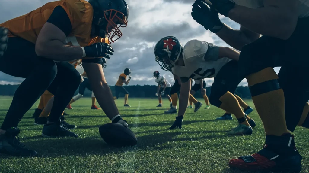 Two Professional American Football Teams Stand Opposite Each Other Ready to Start the Game Defense and Offense Prepare to Fight for the Ball with Desire to Score Points and the Goal and Win