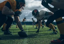 World Cup venues reignite debate as NFL players question continued use of turf fields Two professional American football teams stand opposite each other ready to start the game.