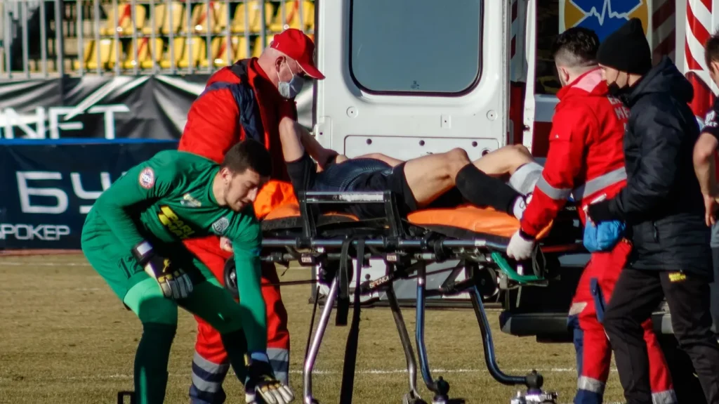 Uzhgorod Ukraine  February 28 2021 Paramedics provide first aid to injured player during the match of the Ukrainian Premier League between FC Minai Minai and FC Olimpic Donetsk