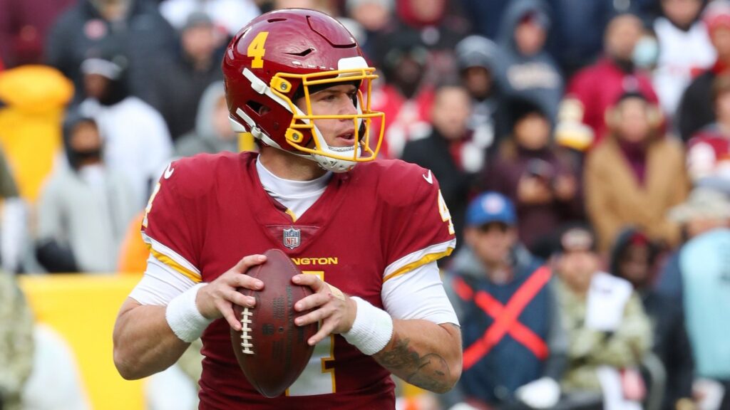 Taylor Heinicke attempts to throw a pass during an NFL game.