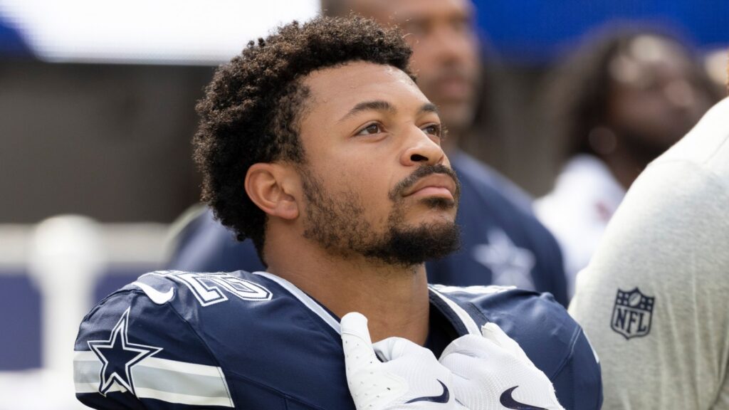 Deuce Vaughn #42 stands for the national anthem before an NFL preseason football game against the Rams at SoFi Stadium.