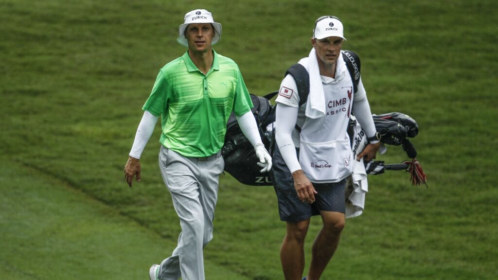 Ben Crane of the United States walks with his caddie during the at TPC Kuala Lumpur, Bukit Kiara.