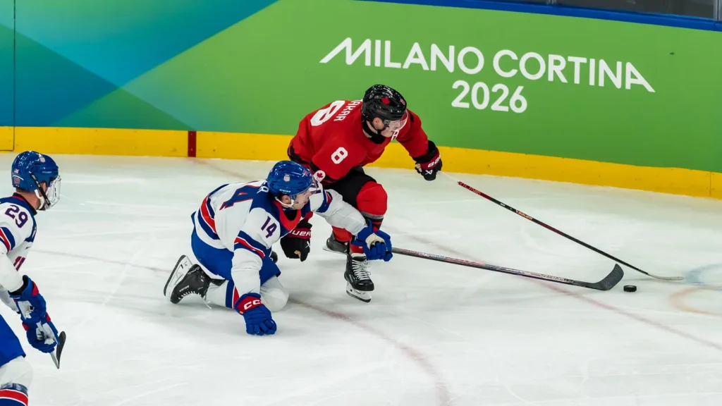 Defender Cale Makar 8 of Team Canada fights for the puck