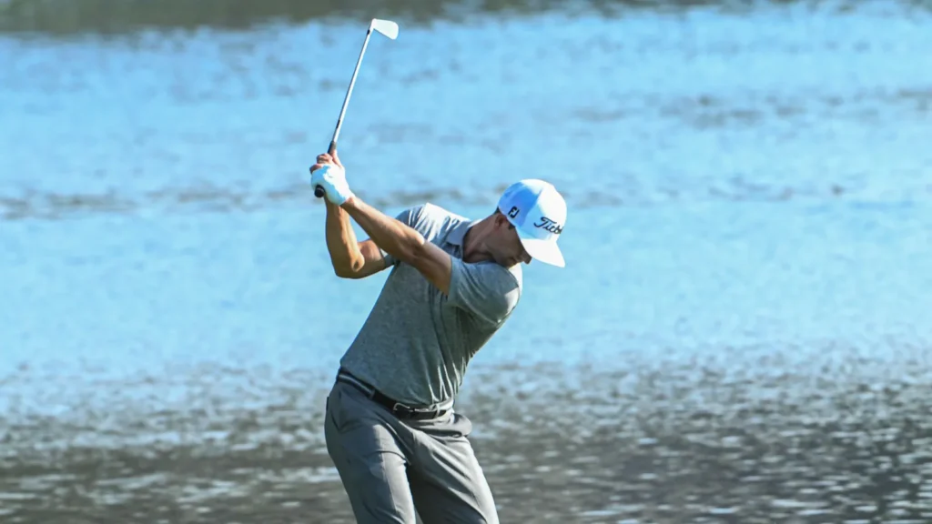 Adam Scott preparing to hit the ball during golf match.