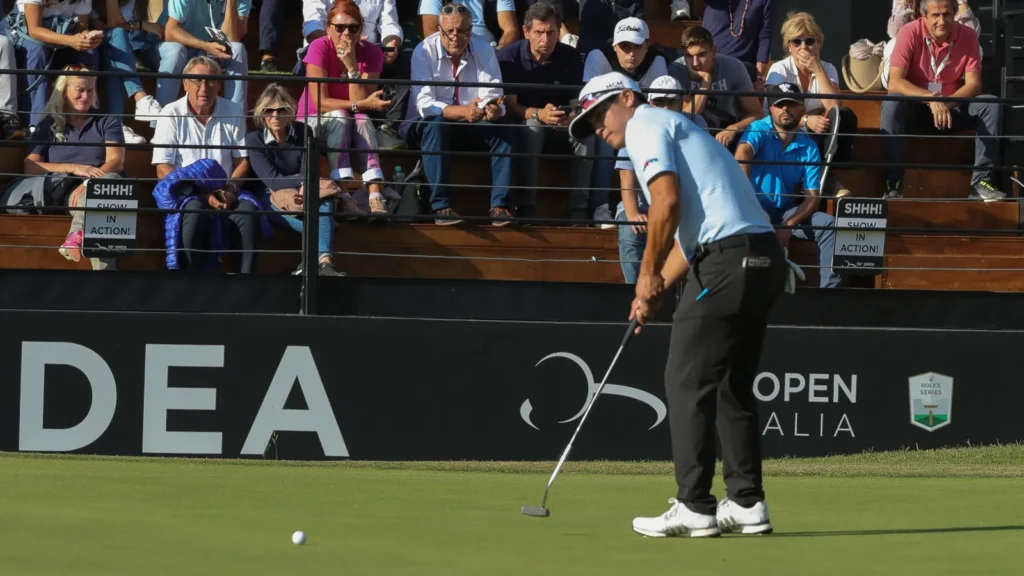 Kurt Kitayama aiming a putt during a professional tournament