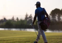 LIV Golf’s biggest names face an uncertain future as Saudi backing fades golfer walking and carrying golf bag at beautiful sunset