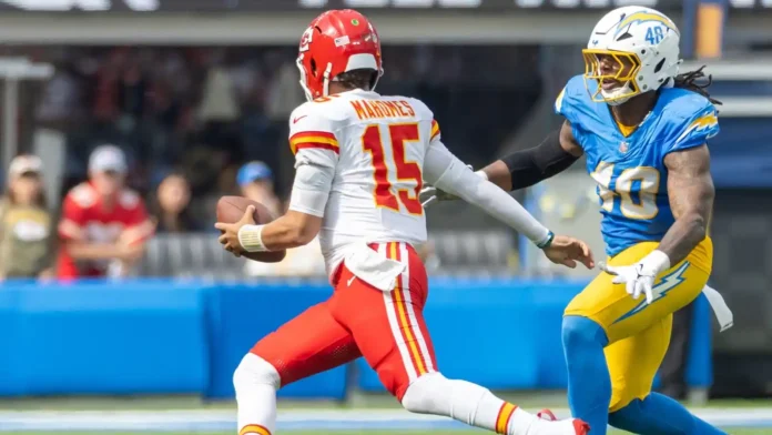 Patrick Mahomes runs to escape a tackle Patrick Mahomes runs to escape a tackle