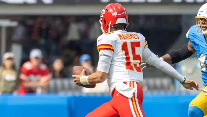Patrick Mahomes runs to escape a tackle