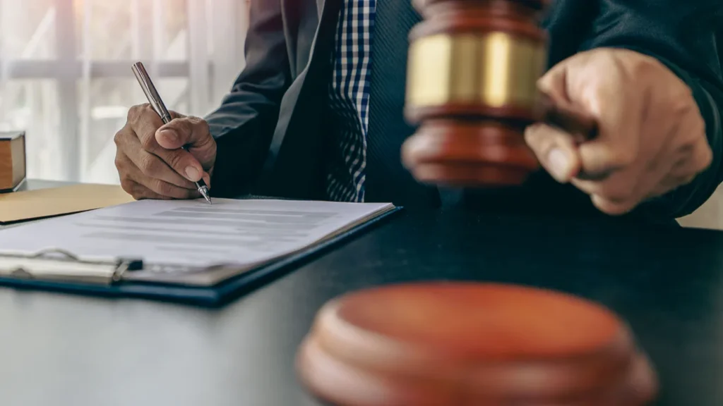 A judge banging the gavel and writing