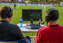 Back view of commentators commentating on a game
