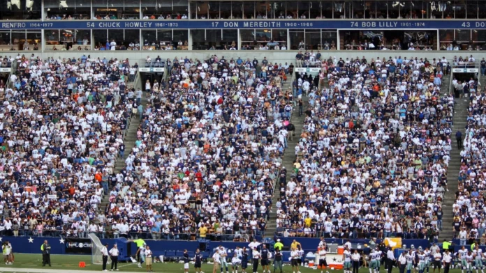 A crowd of spectators in a football stadium, featuring a Dallas Cowboys Ring of Honor section