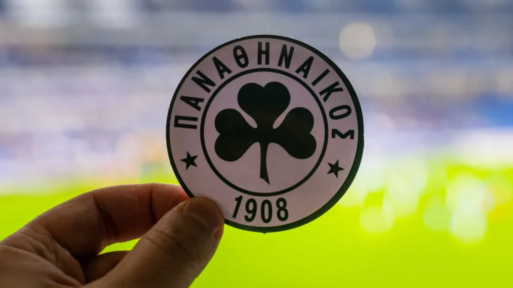 September 12 2021 Athens Greece The emblem of the football club Panathinaikos F C and the UEFA Champions League Cup on the background of a modern stadium