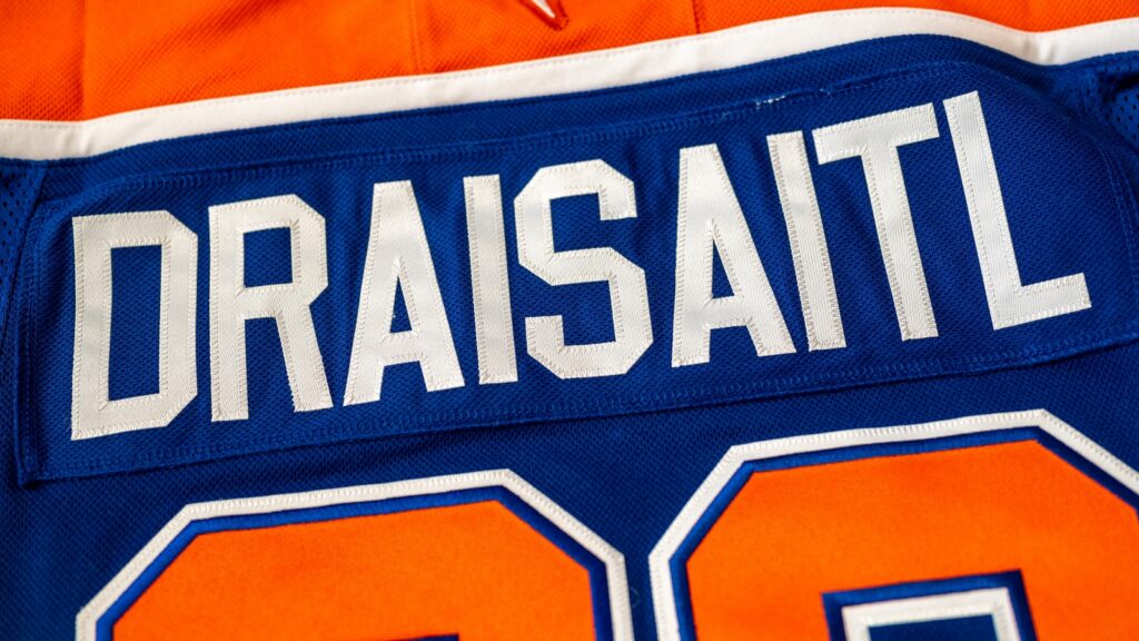 Blue and orange Edmonton Oilers hockey sweater, with name and number of Leon Draisaitl