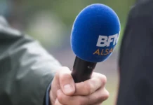 Strasbourg  France  17 September 2022  Closeup of blue bfmtv microphone in hand of journalist in the street