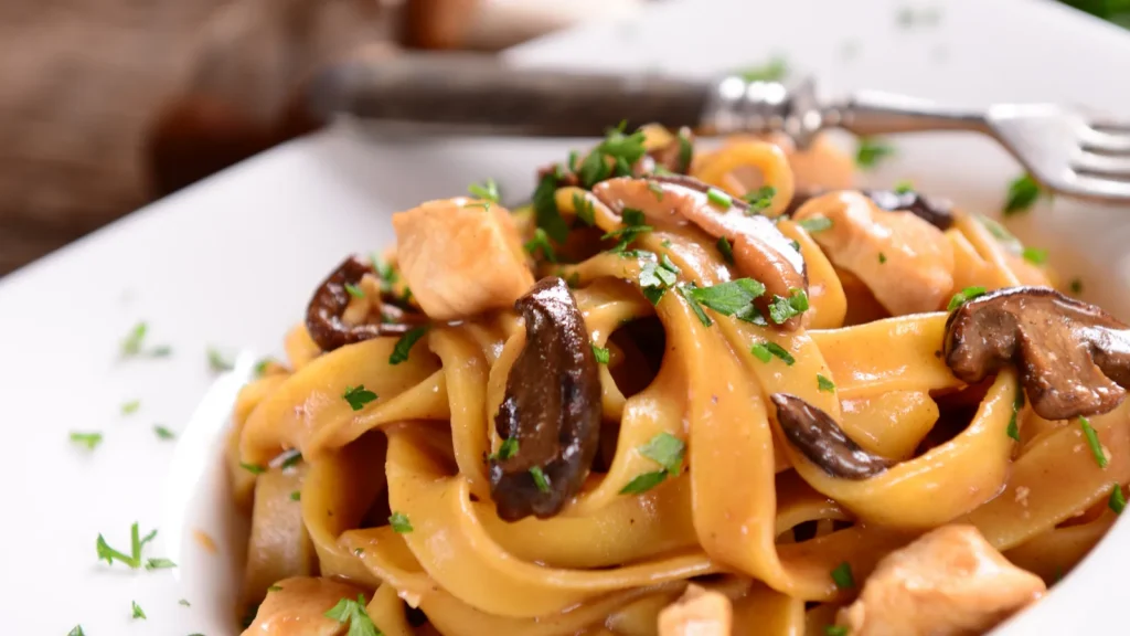 Tagiatelle pasta with creamy sauce with porcini mushrooms and chicken