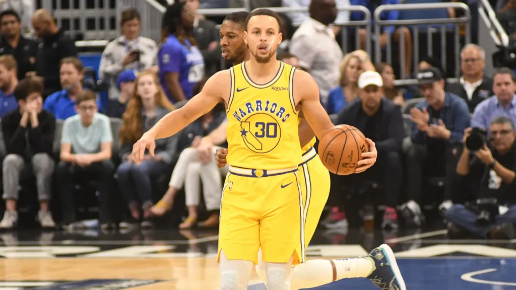 Stephen Curry holding a basketball during an NBA game.