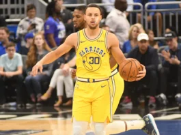 Stephen Curry holding a basketball during an NBA game.
