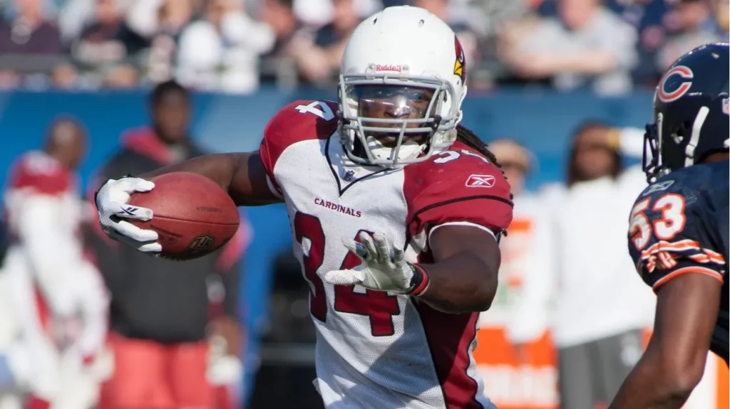 Tim Hightower running back looking for a big yardage gain as he runs down the field at a NFL game