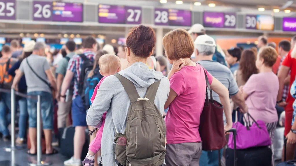 Passengers waiting for registration at airport.